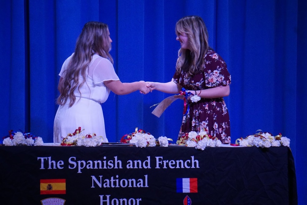 student shakes hands with teacher